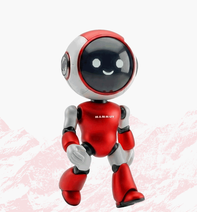 A smiling red and white robot toy with a black face, standing against a light background featuring Mammut-brand pink mountains.