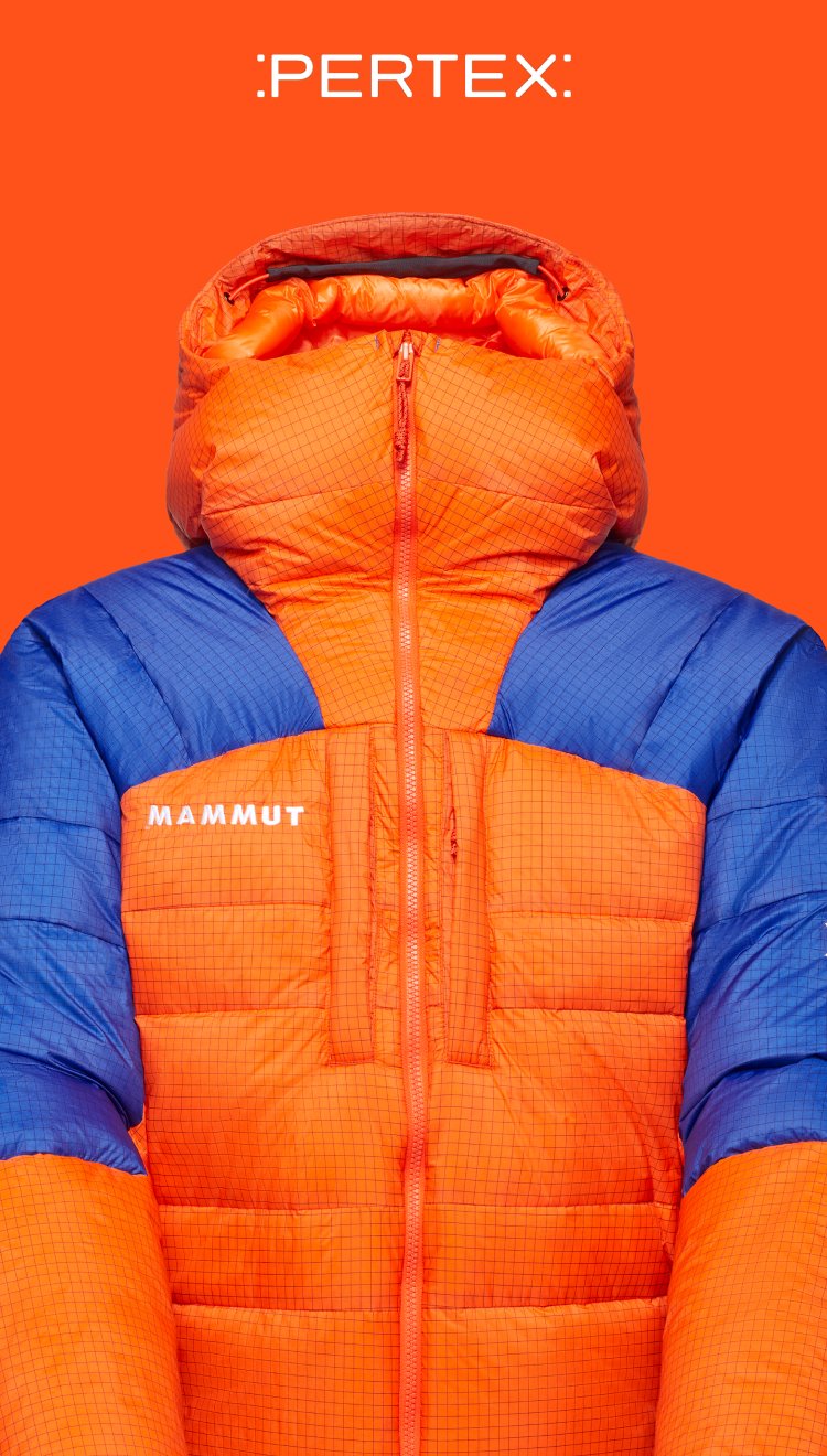 Bright orange and blue Mammut mountaineering puffer jacket with hood, displayed on orange background with Pertex logo above.