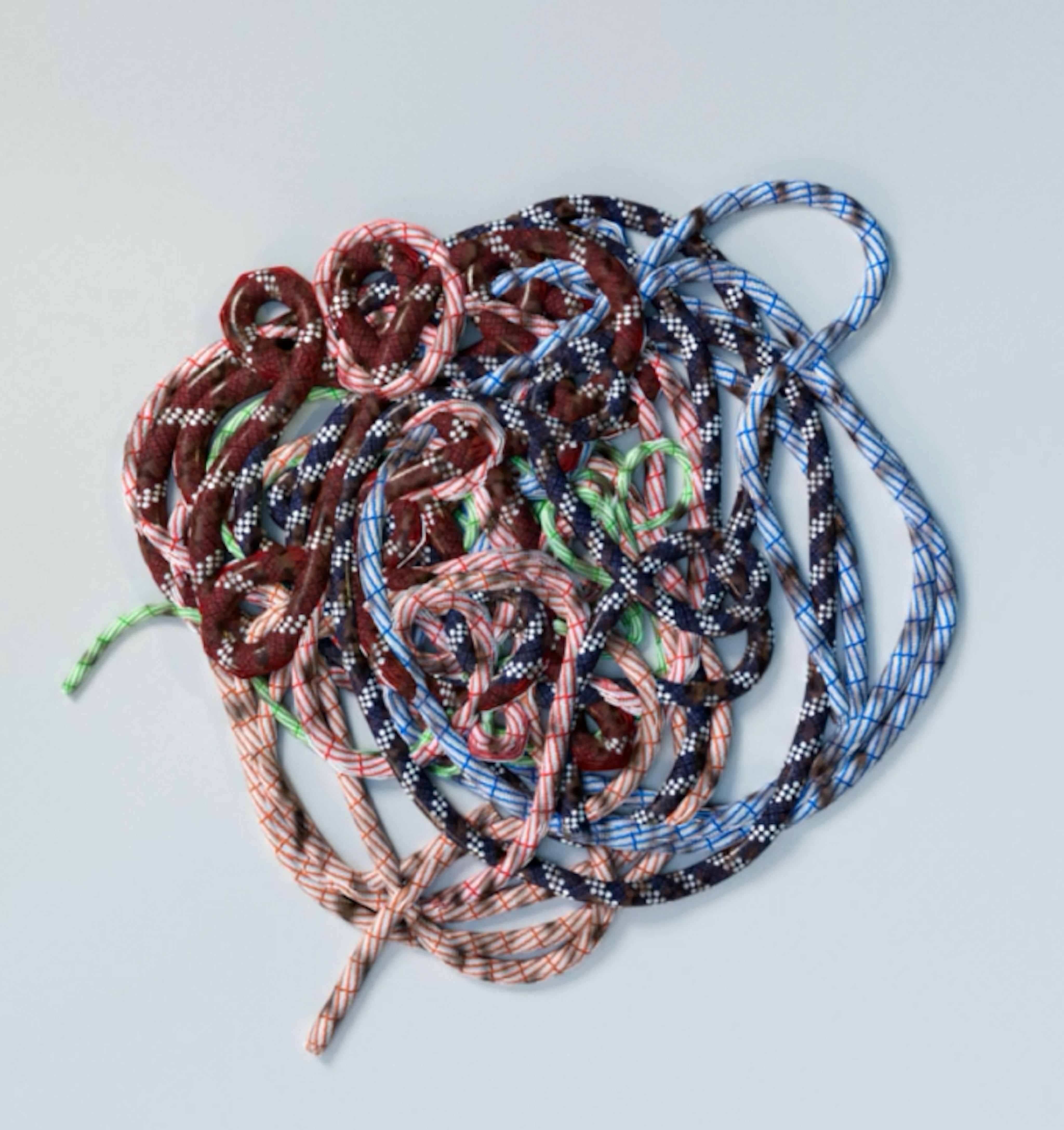 Tangled colorful Mammut climbing ropes in various patterns and colors against a light background.