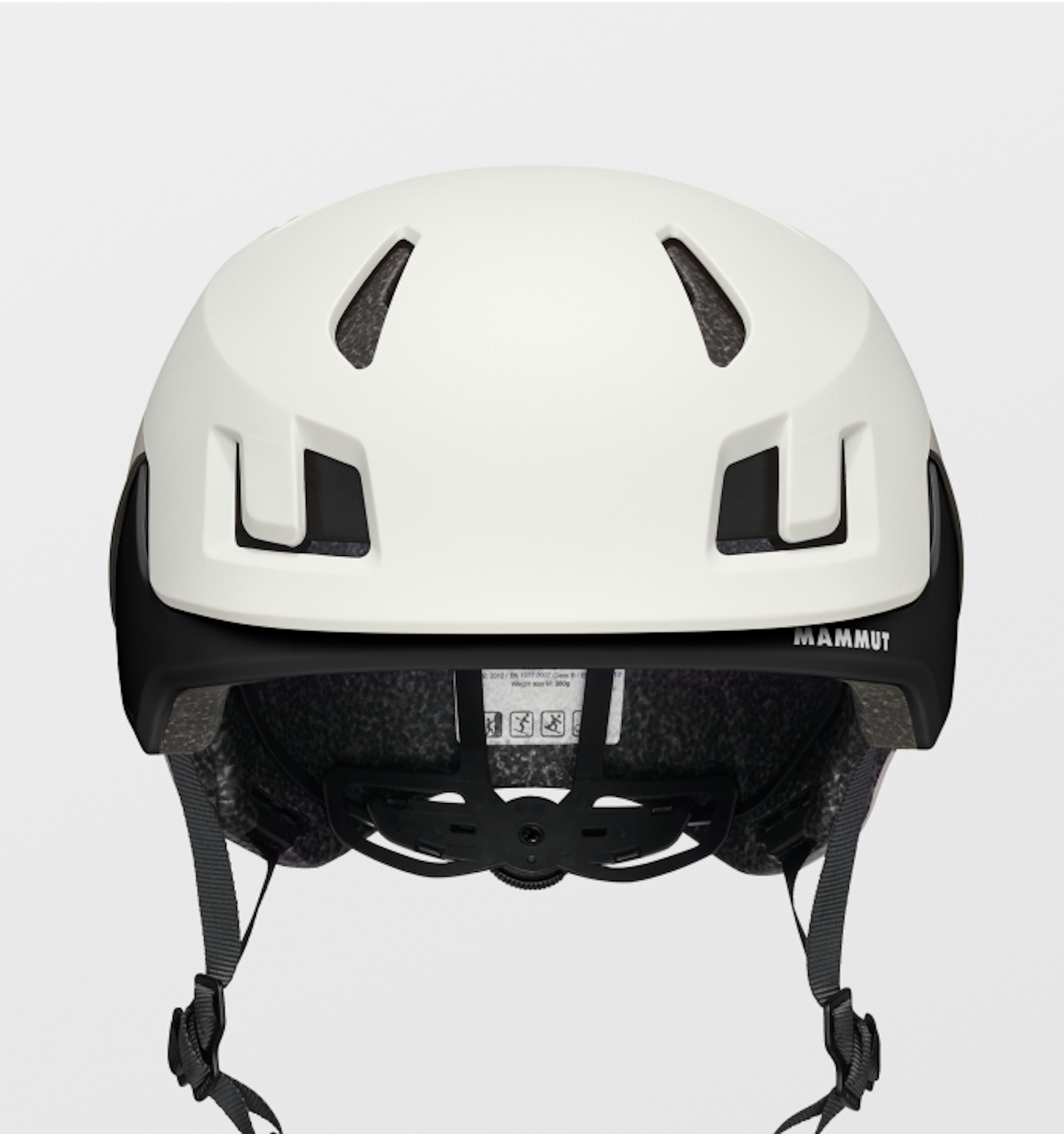 Mammut white haute route helmet with black trim, featuring ventilation slits and adjustable straps, viewed from the back.