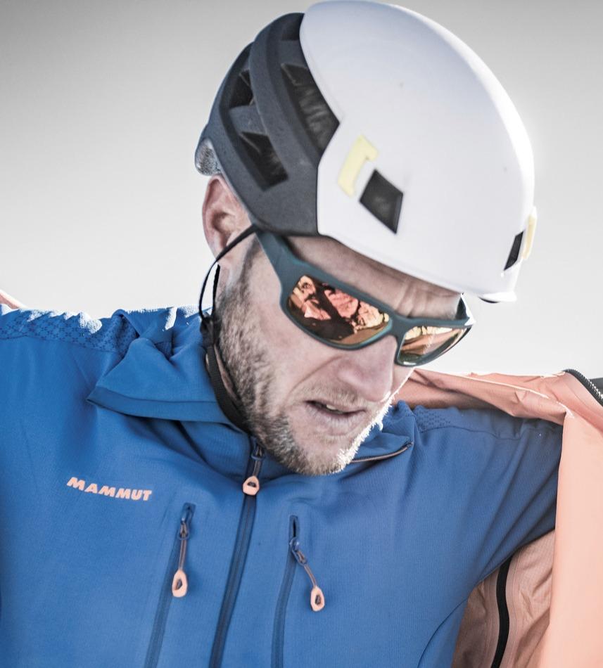Man wears blue Mammut jacket