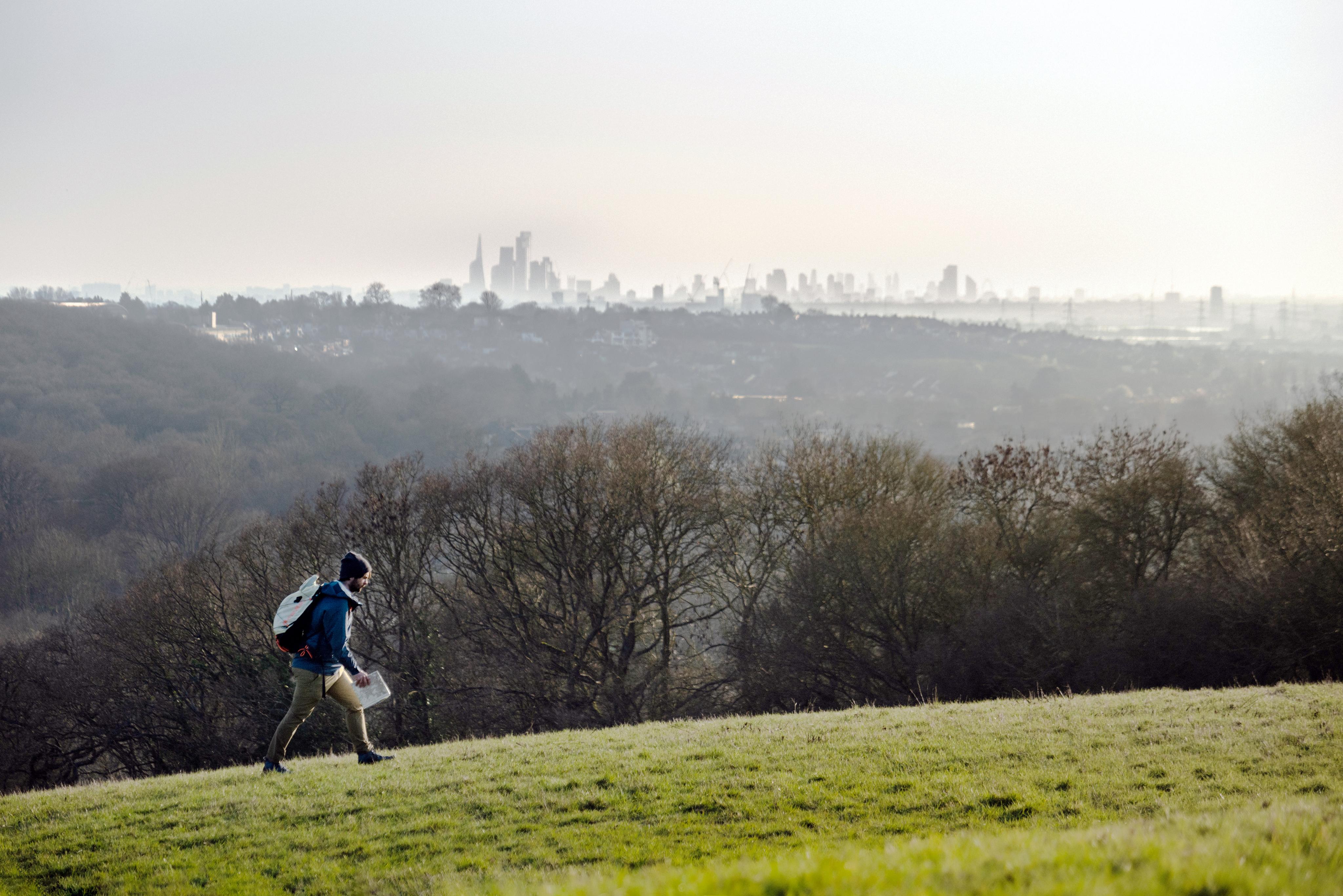 Hiker on a mountain with a skyline.